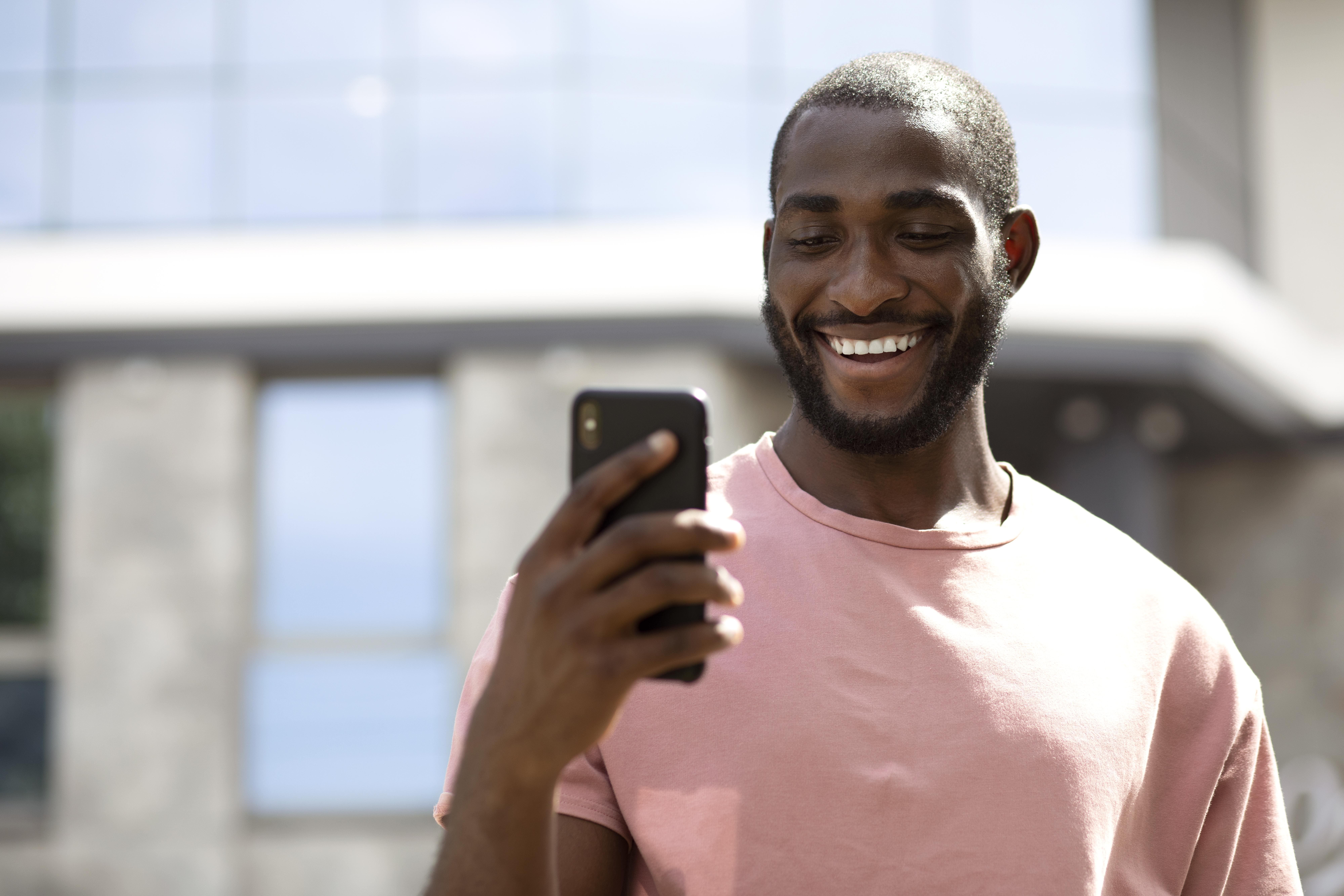 Man smiling at his phone